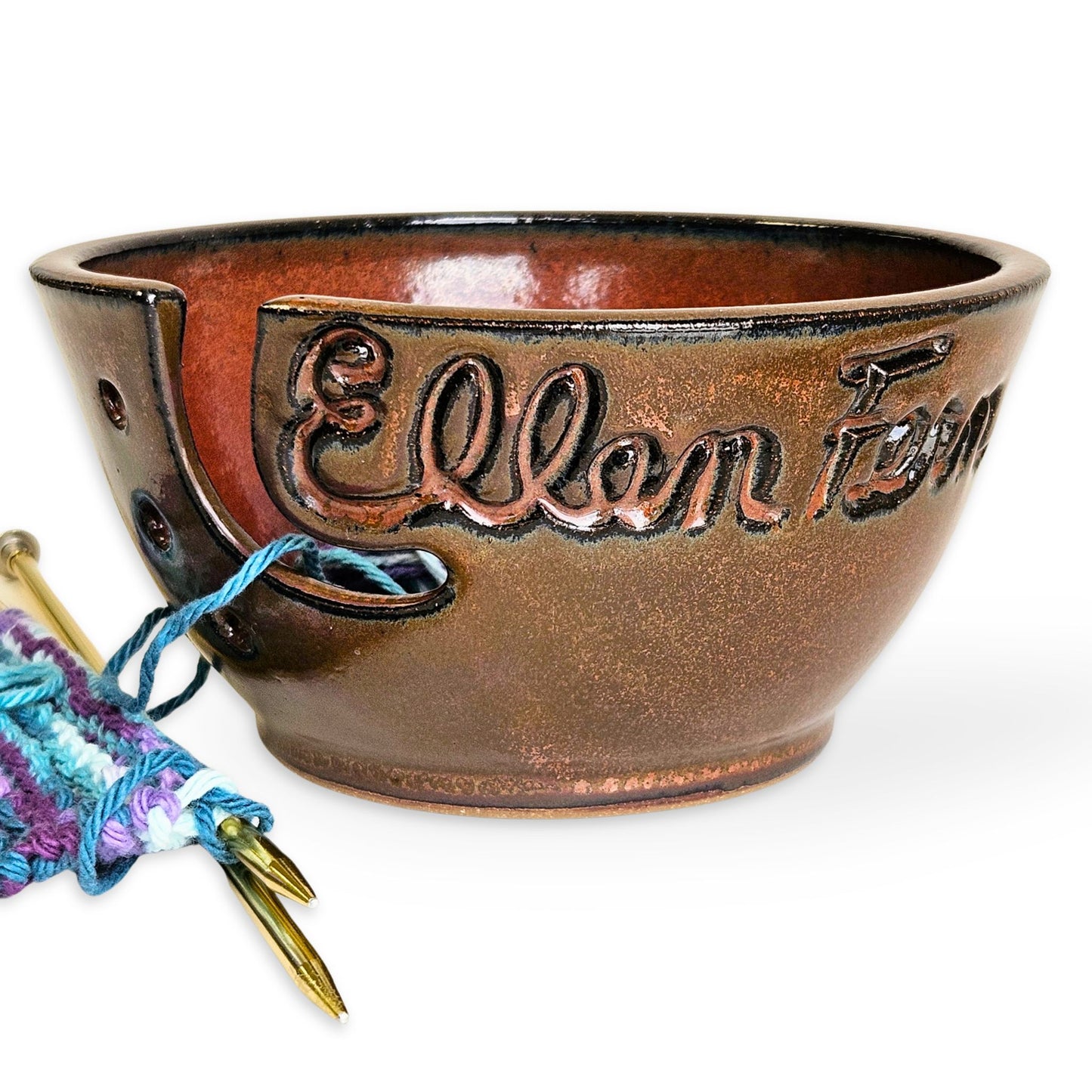 Handmade artisan ceramic yarn bowl with custom 'Ellen' carving. Brown pottery yarn holder with guide slot and needle holes. Thoughtful handmade gift for moms, grandmas, family or friends that knit or crochet.