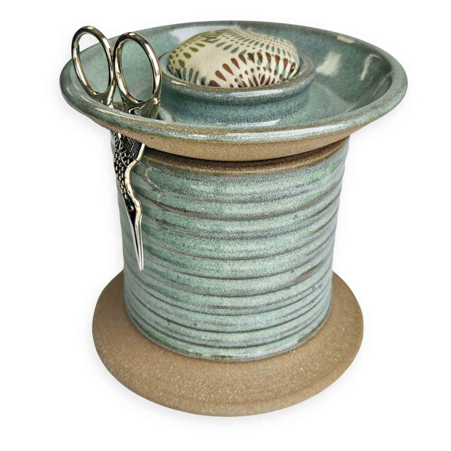 Handcrafted pottery sewing caddy designed to organize creative spaces, featuring compartments for bobbins, scissors, thread spools, and pins. This sturdy and charming piece transforms a cluttered sewing table into an inspiring, tidy workspace. A beautiful and practical gift for sewing moms, grandmothers and aunts who appreciate thoughtful, artisanal tools. The Mud Place, handmade in the USA