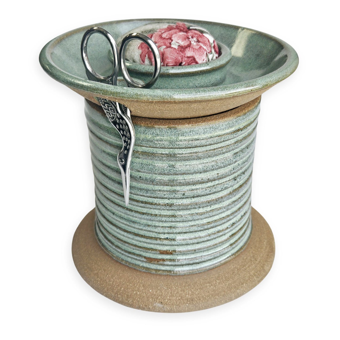 Handcrafted pottery sewing caddy designed to organize creative spaces, featuring compartments for bobbins, scissors, thread spools, and pins. This sturdy and charming piece transforms a cluttered sewing table into an inspiring, tidy workspace. A beautiful and practical gift for sewing moms, grandmothers and aunts who appreciate thoughtful, artisanal tools. The Mud Place, handmade in the USA