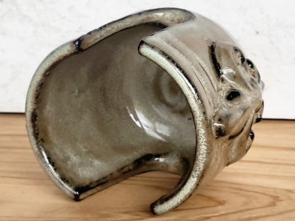 Inside view of handmade artisan bronze ceramic sponge holder with embossed fleur-de-lis design, can hold a cotton crochet scrubber sponge. Eco-friendly kitchen countertop accessory perfect for storing crochet scrubbers, dish sponges, and sink cleaning essentials.