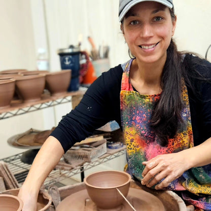 Leslie of The Mud Place throwing bowls on a pottery wheel