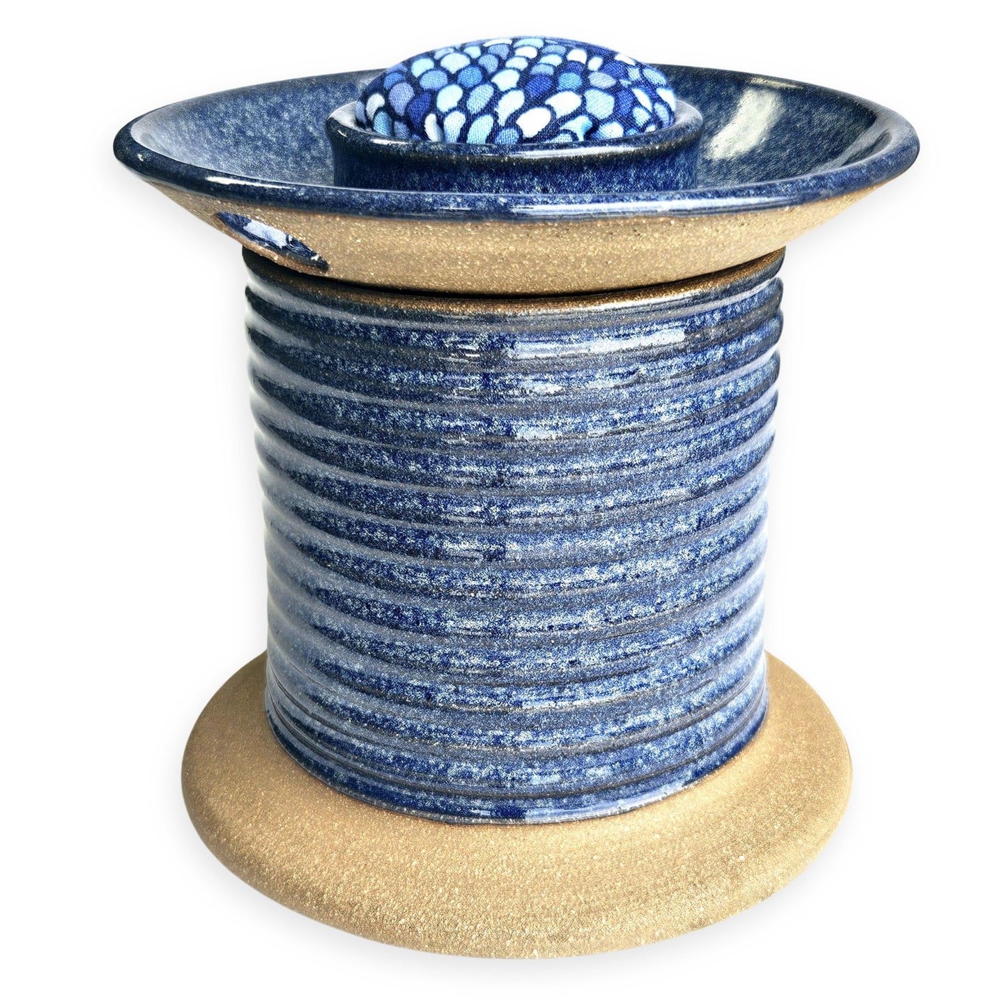 Handmade ceramic sewing caddy shaped like an oversized spool, in vibrant blue glazes, with a fabric-topped pincushion, scissors slot, and removable lid for storage. mermaid pincushion fabric