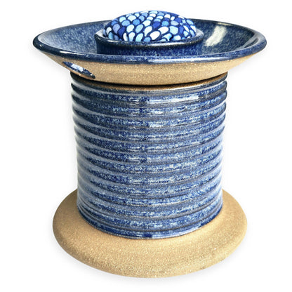 Handmade ceramic sewing caddy shaped like an oversized spool, in vibrant blue glazes, with a fabric-topped pincushion, scissors slot, and removable lid for storage. mermaid pincushion fabric