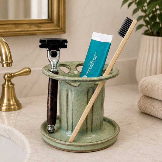 Organized bathroom sink with artisan green toothbrush holder, toothpaste storage and convenient shaving razor holder