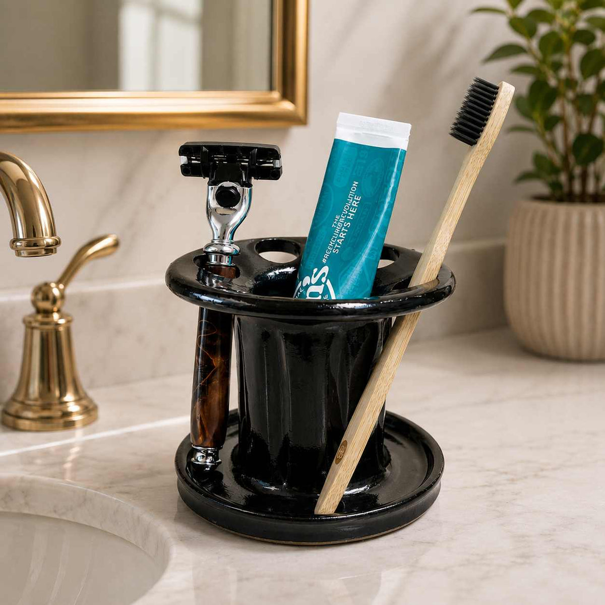 Clutter-free bathroom sink with black toothbrush organizer, toothpaste storage and shaving razor holder