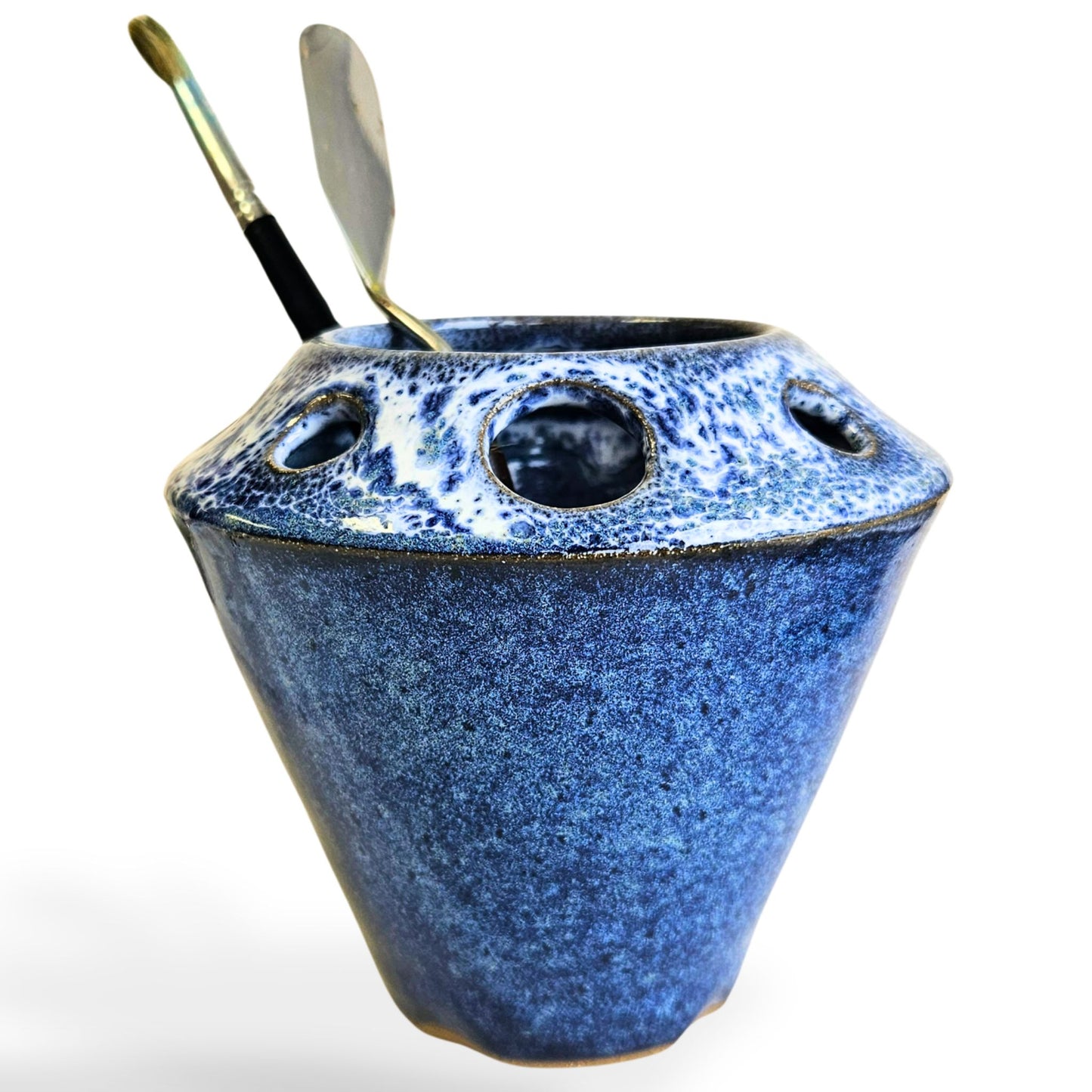 Handmade ceramic pottery tool caddy in blue glaze, featuring a flared cone shape with multiple round openings around the rim for organizing art supplies, pens, pencils, brushes, or scissors. Unique handcrafted desk organizer, perfect for artists, crafters, or pottery lovers.