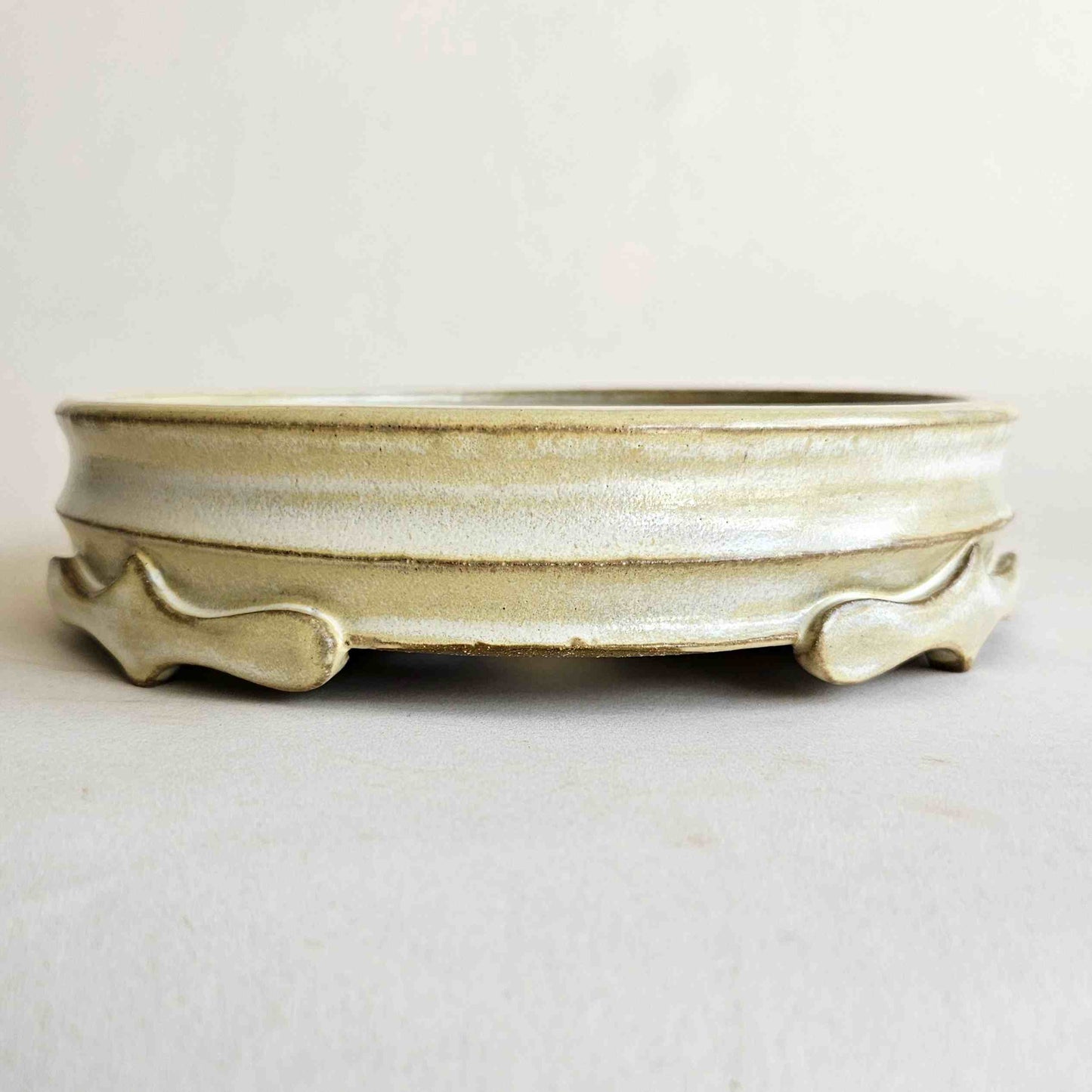 Round 8-inch yellow glazed ceramic bonsai pot for deciduous, flowering, and fruiting bonsai trees.
