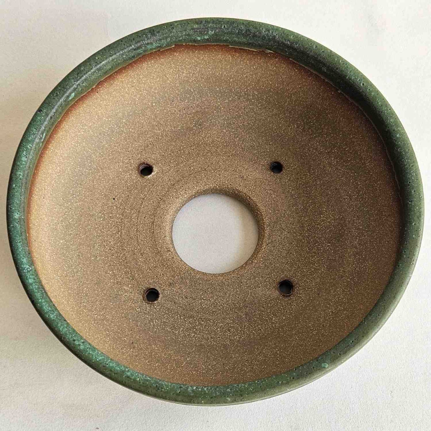 Interior of a 6.75-inch shohin bonsai pot with one drainage hole and four tie-down holes for repotting.
