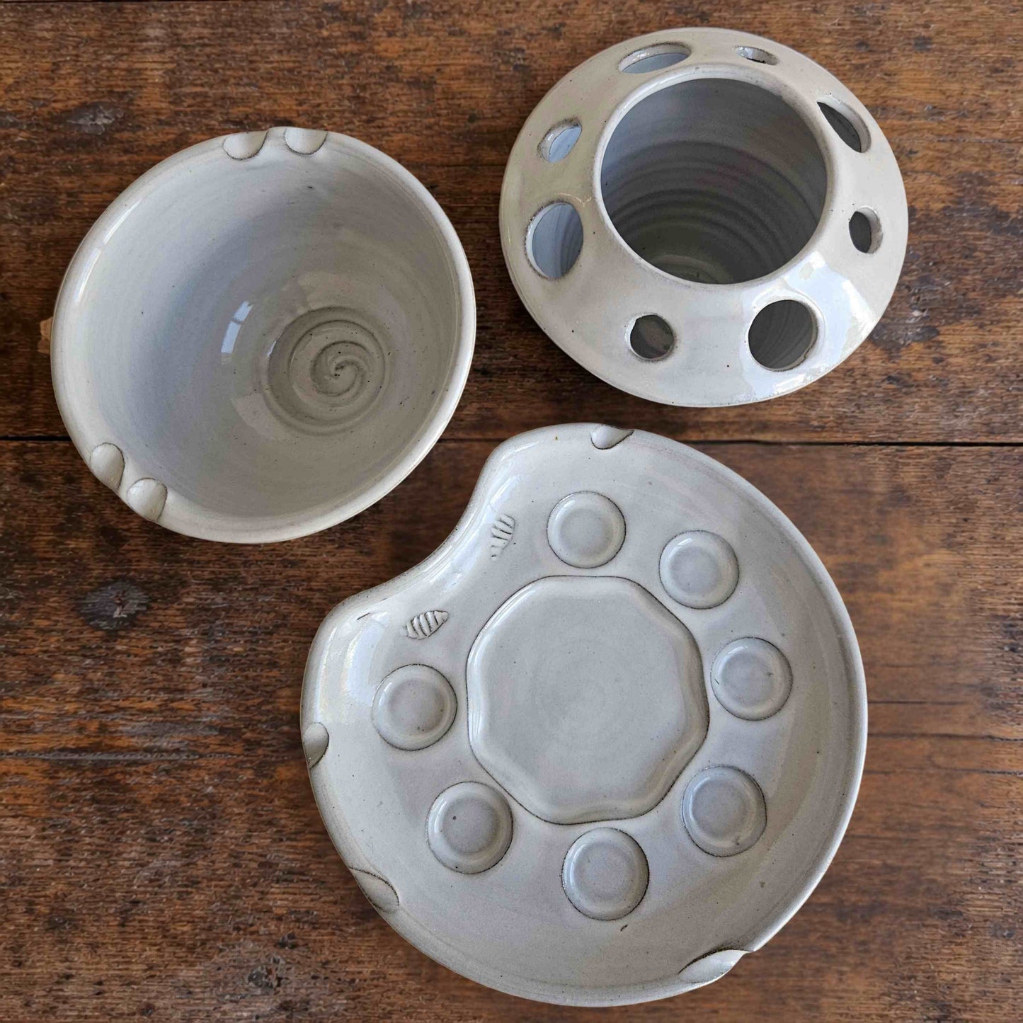 Top view of handmade ceramic paint palette set including palette, brush caddy, and rinse bowl in white glaze.
