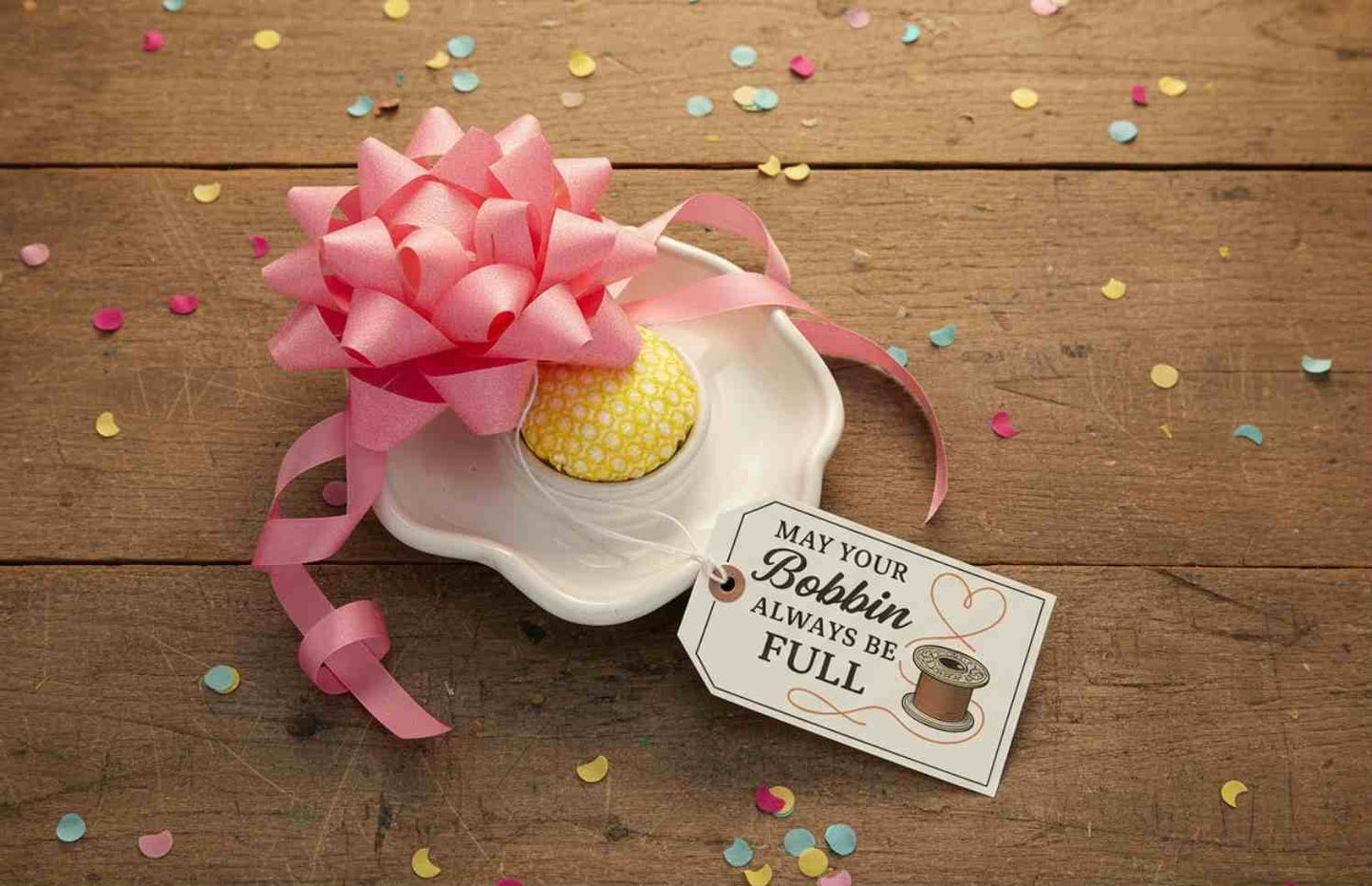 Sewing-themed printable wall art crafted into a birthday gift tag. Prints include quotes like “It’s Not Hoarding If It’s Fabric,” “May Your Bobbin Always Be Full,” “Measure Twice Cut Once,” and “Sewing Is My Love Language,” styled in warm tones with vintage illustrations.