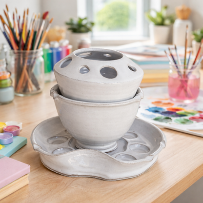 Handmade ceramic paint palette system with brush caddy and rinse bowl stacked together for compact storage.