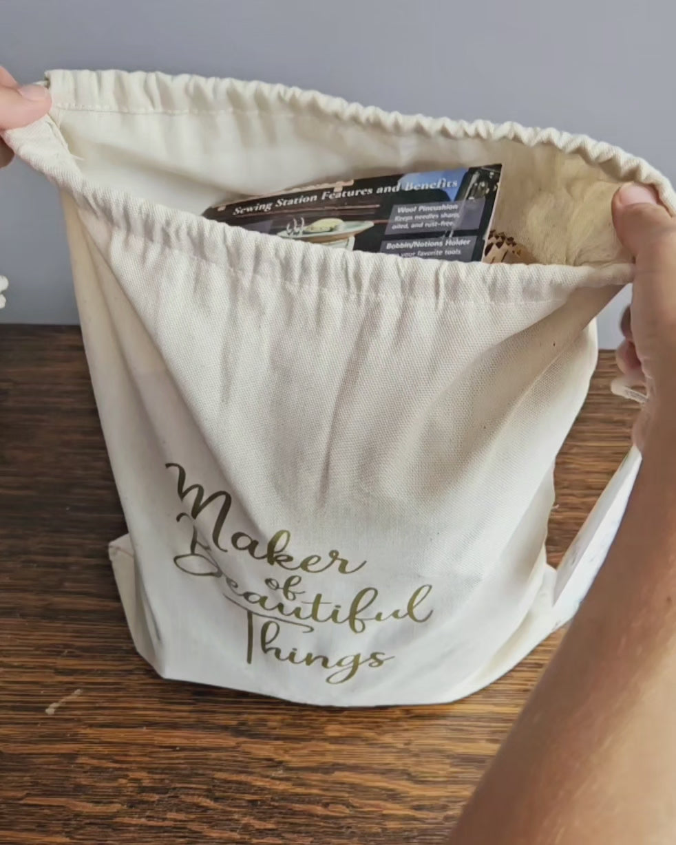 Video for Canvas Project Gift Bag Wrap. Reusable canvas gift bag with gold “Maker of Beautiful Things” script and a gift tag that reads “Given with Love, Made with Heart.” A perfect gift wrap for handmade items, pottery, or artisan gifts — ideal for Christmas, Mother’s Day, or holiday gifting option for The Mud Place. 