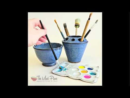 Handmade paint palette set in use with multicolored paints and brushes showing the matching white palette, paintbrush rinse bowl and brush caddy.