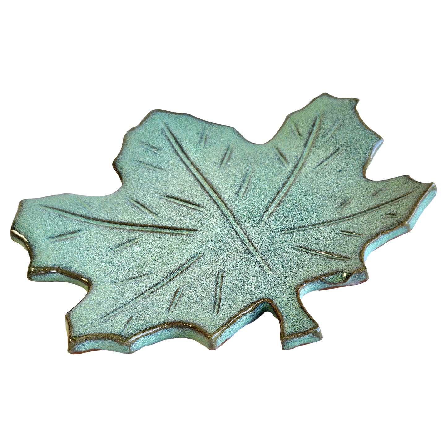 Side angle of handmade ceramic maple leaf spoon rest showing curved edges and glaze finish