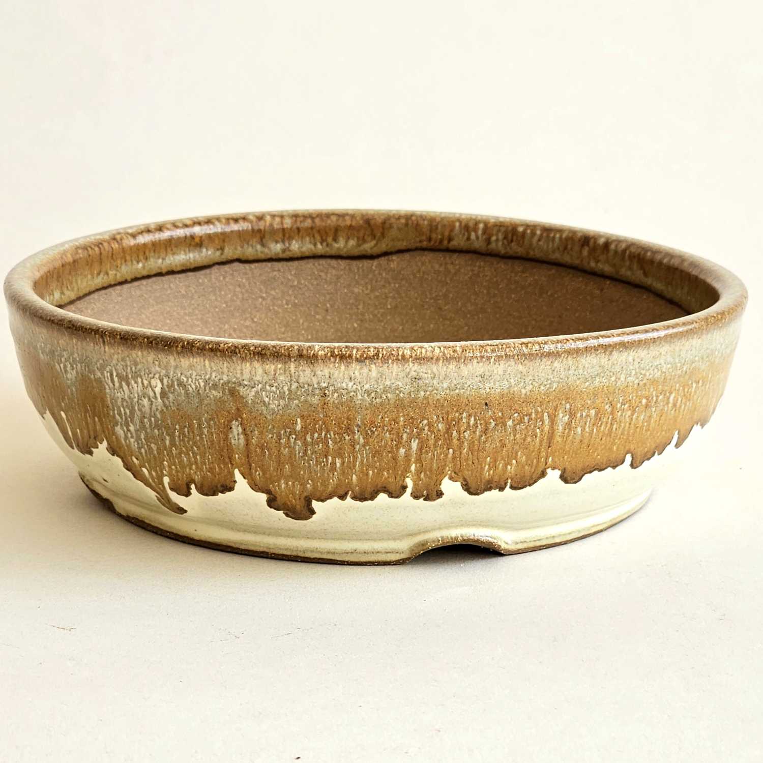 Low round bonsai pot with a satin yellow finish, flowing bronze details, and a straight rim.