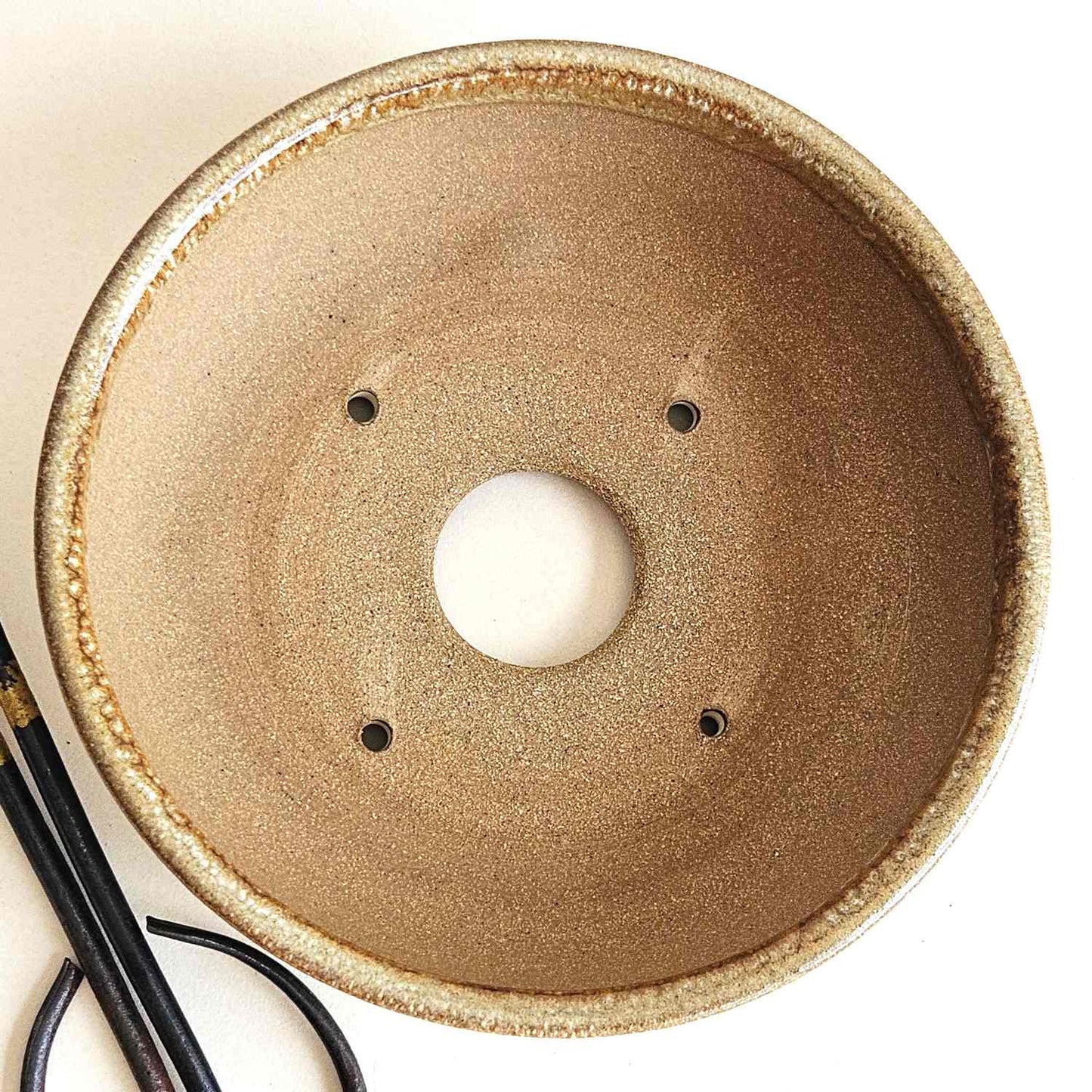 Interior of a 6.75-inch shohin bonsai pot with one drainage hole and four tie-down holes for repotting.