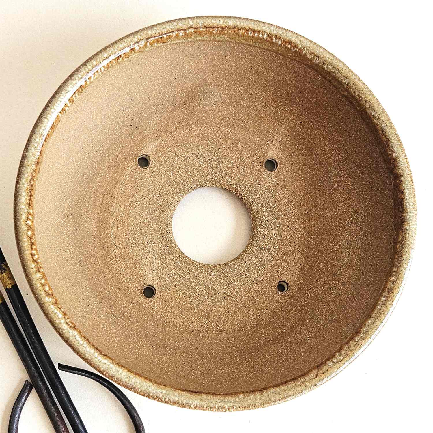 Interior of a 6.75-inch shohin bonsai pot with one drainage hole and four tie-down holes for repotting.